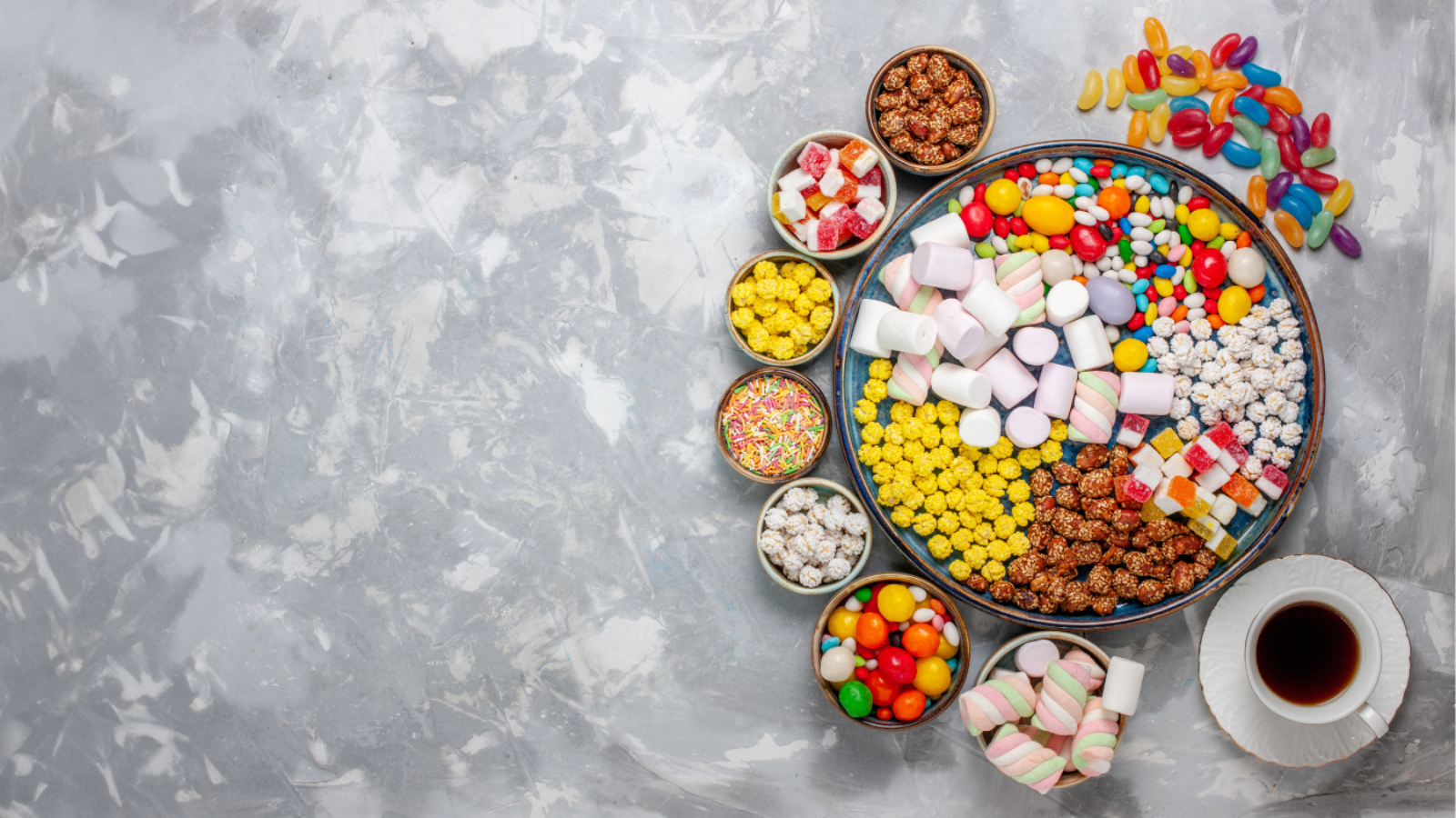 top-view-candy-composition-different-colored-candies-with-marshmallow-tea-white-desk-sugar-candy-bonbon-sweet-confitures