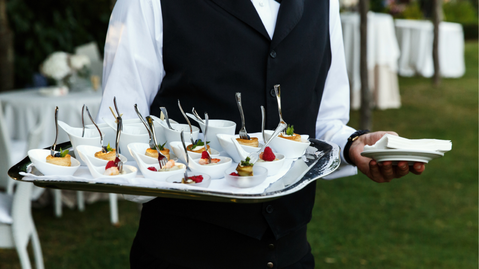 waiter-carries-plate-with-tasty-snacks